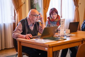 A group of people taking part in an editathon “Ženy ve vědě” (Women in Science)